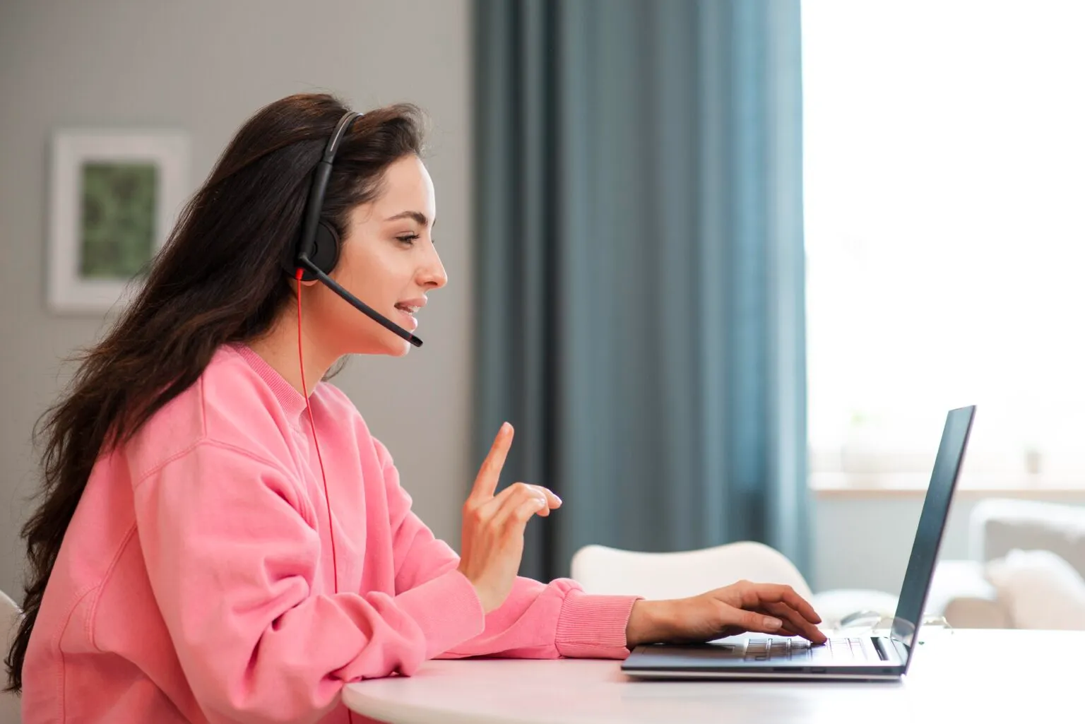 Assistant on a call working at laptop